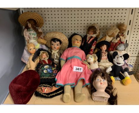 A group of vintage dolls and toys.