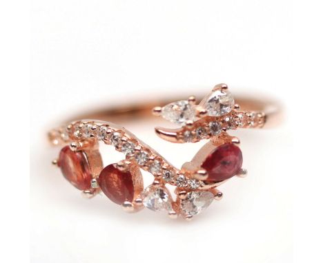 A 925 silver rose gold gilt ring set with fancy orange sapphires and white stones, (N).