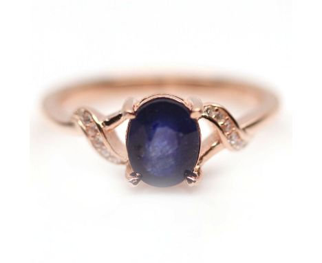 A 925 silver rose gold gilt ring set with an oval cut sapphire, (P).