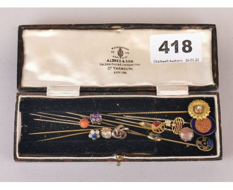 A collection of antique stone set stick pins.