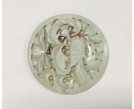 A Chinese carved nephrite jade disc of a bird among foliage, possibly from a box lid, Dia. 9.5cm.