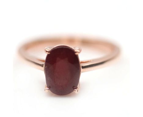 A 925 silver rose gold gilt solitaire ring set with an oval cut ruby, (N).