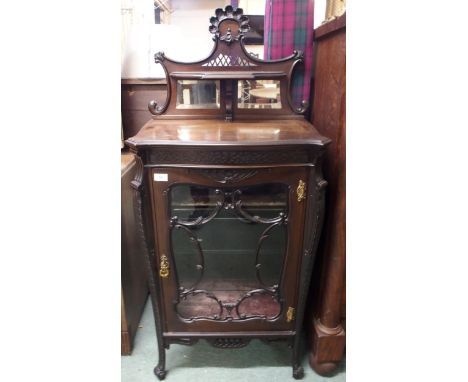 A Victorian mahogany music cabinet with bevelled mirror surmount over single glazed door on scrolled supports, 132cm high x 6