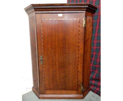 A Victorian oak panel door hanging corner cabinet, 99cm high x 78cm wide Condition Report:Available upon request