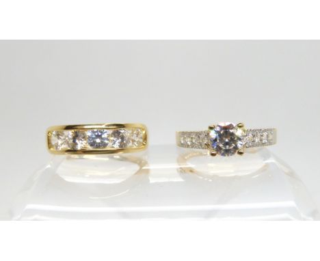 Two 14k gold cubic zirconia rings, solitaire ring size O1/2, five stone O1/2, weight together 7.1gms Condition Report:Very li