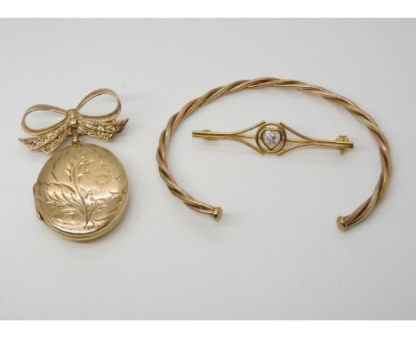 A 9ct gold locket brooch with bow mount, a 9ct gold bangle and a brooch, weight together 15gms Condition Report:Available upo