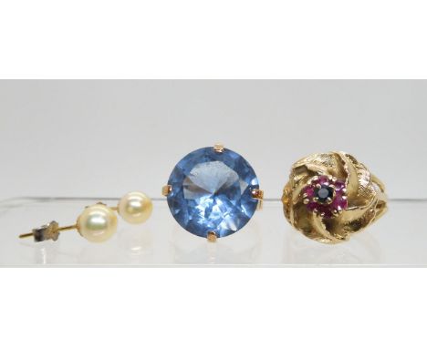 An Arabic gold ring set with a large blue gem, size P, and a 9ct gold ruby and sapphire ring&nbsp; size Q, and a pair of pear
