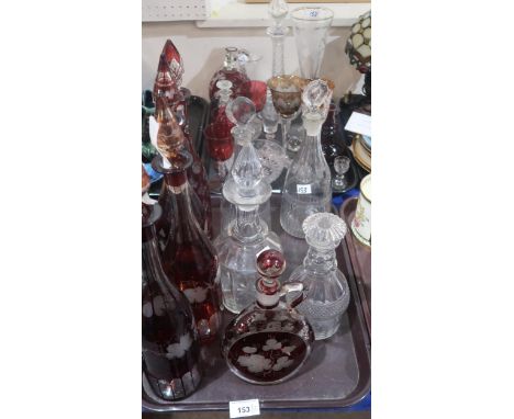 A collection of antique glassware including a set of three ruby flashed and glass bottle decanters, a large vine etched glass