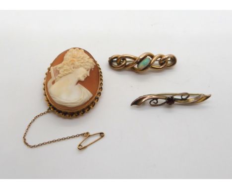 A 9ct gold mounted cameo brooch, a yellow metal opal brooch and a 9ct red gem brooch, weight together 17.5gms Condition Repor