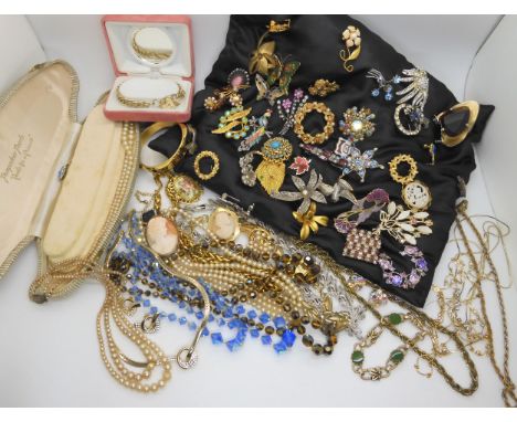 A large collection of vintage brooches, beads, necklaces etc Condition Report:No condition report available.