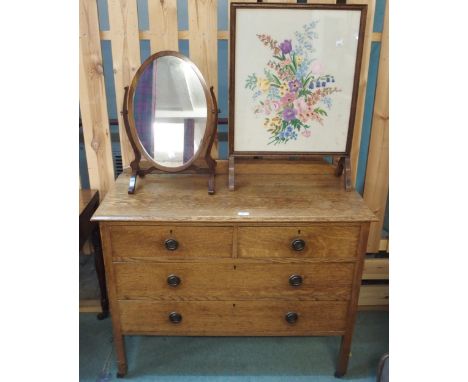 An early 20th century oak two over two chest of drawers, 82cm high x 107cm wide x 48cm deep, oak framed tapestry fire screen 