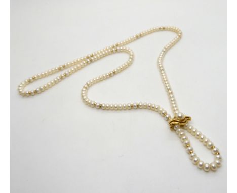 A string of button cultured pearls with gold bead detail and a 9ct gold removable pearl clasp, weight of clasp 2.9gms Conditi