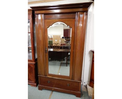 A late Victorian mahogany wardrobe with moulded cornice over single mirrored door over single drawer on plinth base, 203cm hi