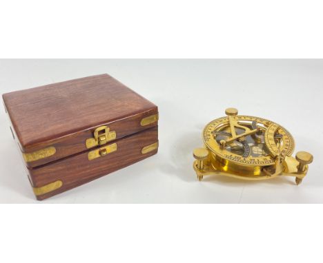A marine sundial compass standing on 3 screws 13cm dia within a brass-bound wooden box 14x14x6cmApprox 2 pieces