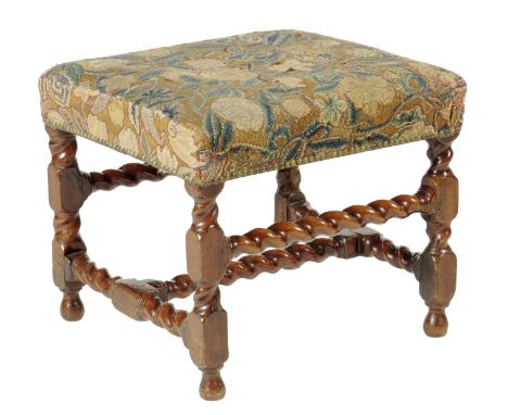 A walnut stool, the stuffed-over seat covered in floral tapestry on spiral twist and block supports, united by an 'H' stretch