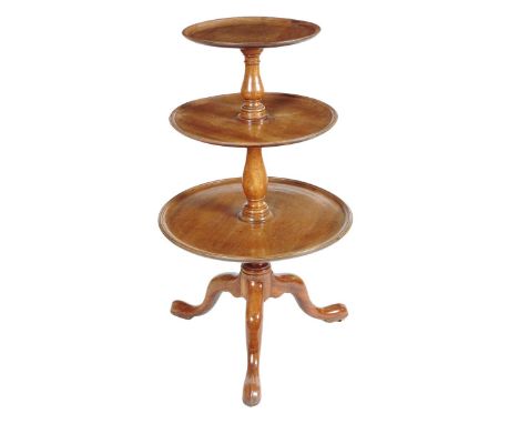 A George III mahogany dumb waiter, with three graduated revolving dished tiers, on baluster turned stems and brass roller cas