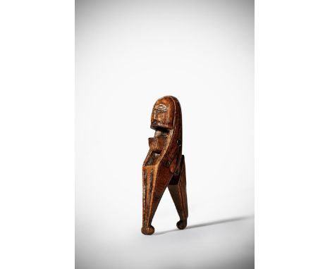 A rare treen lever action nutcracker, carved in the form of a bearded man with a flat face above a fluted tapering handle, pr