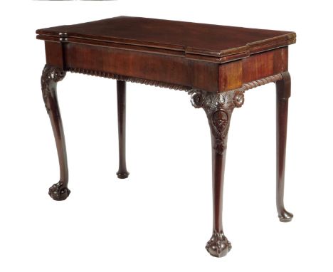 A George II and later mahogany card table, the inverted breakfront fold-over top revealing a baize lined playing surface with