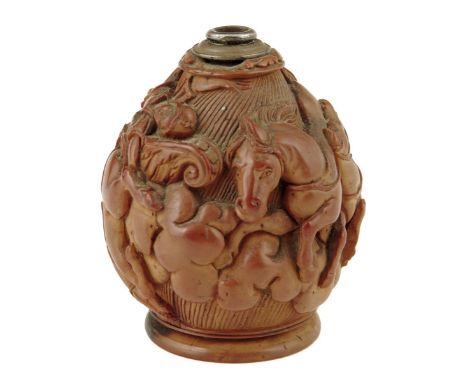 An early 19th century French carved coquilla nut snuff flask, with a white metal top with a body carved with a soldier and fi