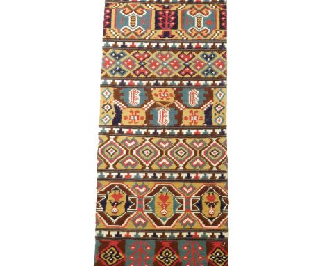 A Swedish flat weave tapestry runner, with panels of geometric designs, figures, dated '1883 and with initials 'IK D', probab