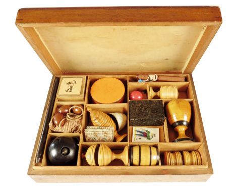 A Victorian magic set, the mahogany box with a lift-off cover revealing a divided interior with various turned boxwood conjur