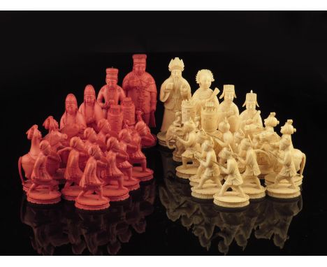 λ A 19th century Chinese ivory chess set, the natural as Chinese figures, the stained red as Europeans, the king: 10.5cm high