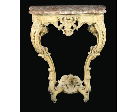An 18th century continental painted and carved wood console table, with a serpentine edge red marble top above a pierced frie