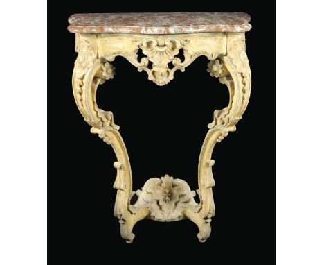 An 18th century continental painted and carved wood console table, with a serpentine edge red marble top above a pierced frie