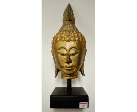 A modern Far Eastern carved giltwood pedestal mask
