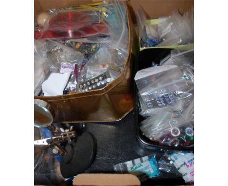 A large collection of assorted costume jewellery making equipment to include sequins, and hand tools, magnifying glass etc