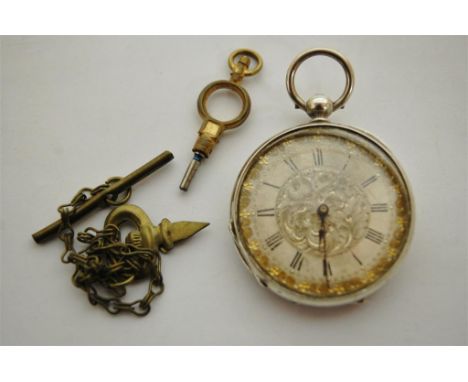 An engine turned silver cased gents pocket watch having keywind movement and housed in olive wood box