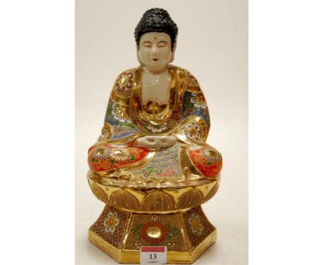A reproduction gilt and enamel decorated earthenware Buddha in seated pose 