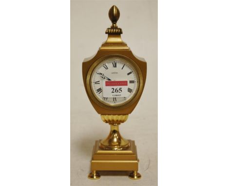 An Angelus lacquered brass cased pedestal mantel clock