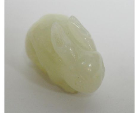 A Chinese carved celadon jade rabbit in crouching pose  Condition Report / Extra Information Slightly rough area to tail, has