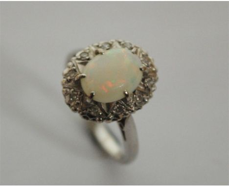 A ladies 18ct white gold opal and diamond cluster ring 