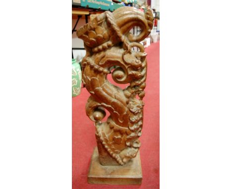 A 19th century South East Asian carved and pierced hardwood architectural element, of floral scroll form, raised on later int