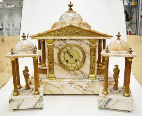 A circa 1900 veined marble three piece clock garniture of architectural outline