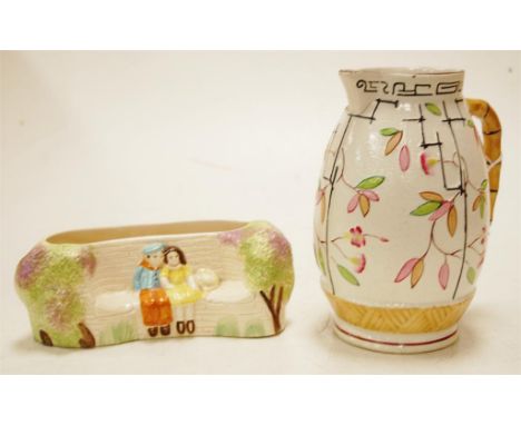 A Victorian polychrome decorated stoneware jug and a Staffordshire posy trough (2) 