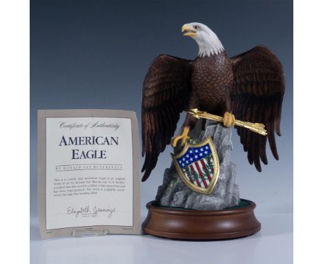 Hand painted fine porcelain figure of a majestic eagle perched on a rock, clutching arrows and standing over an American shie