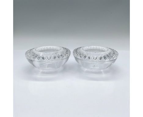 A set of 2 clear round tealight candle holder with an intricate angular facet cuts. Orrefors stickered and marked. This item 