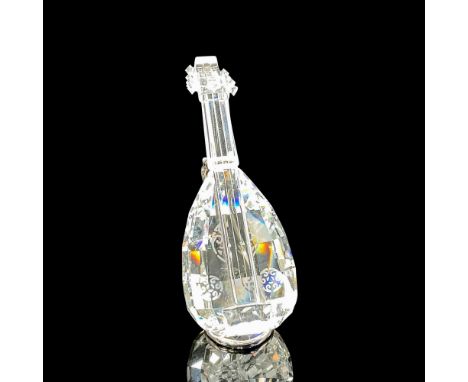 Clear crystal string instrument with a rhodium metal stand. Swarovski backstamp. 7447 000 004. This item has its original box