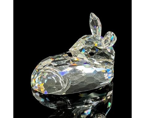 Clear faceted crystal figure of a sweet little deer laying down resting. Swarovski mark. Item number 7608NR000001. Part of th