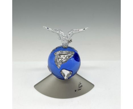 Designed to celebrate the new Millenium a blue crystal globe with clear crystal continents shown is mounted on silver base si