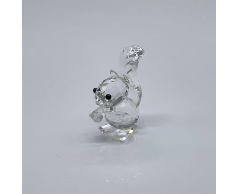 Part of the Woodland Friends collection. Clear long tail squirrel with small ears and black eyes. Show holding a nut. Swarovs