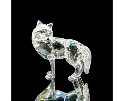 Clear faceted crystal figure of a standing wolf with a frosted tail. Swarovski mark. Item number 7622NR060000. Part of the Fa