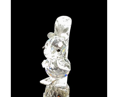 Part of the Woodland Friends Collection, this clear crystal figural with tail up, short ears, jet crystal eyes, holding a nut