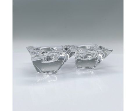 A set of 2 clear square votive candle holders with a twist. Orrefors marked. Issued: c. 2003-2016Dimensions: 3.75"L x 3.75"W 