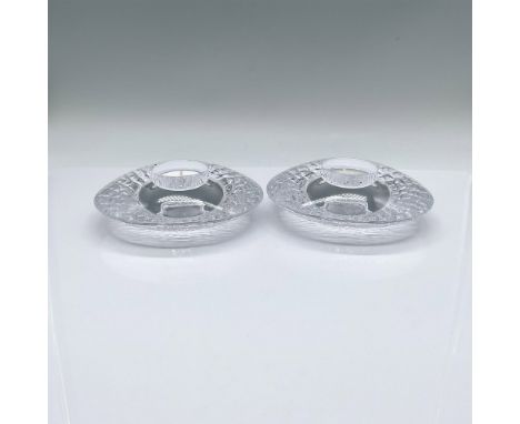 A set of 2 clear votive candle holders. Clear smooth top surface, and textured underside. Orrefors marked. Issued: Late 20th 