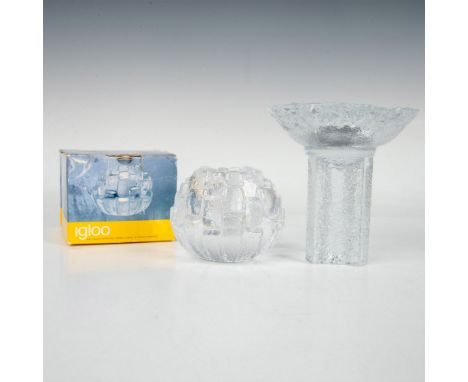 A set of candle holders includes a round one with raised ledges resembling an igloo design, paired with an Olympic torch-insp