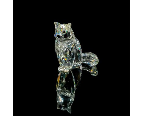 Clear faceted crystal figure of a seated cat looking attentive. Swarovski mark. Item number 7634NR046000. Part of The Peacefu